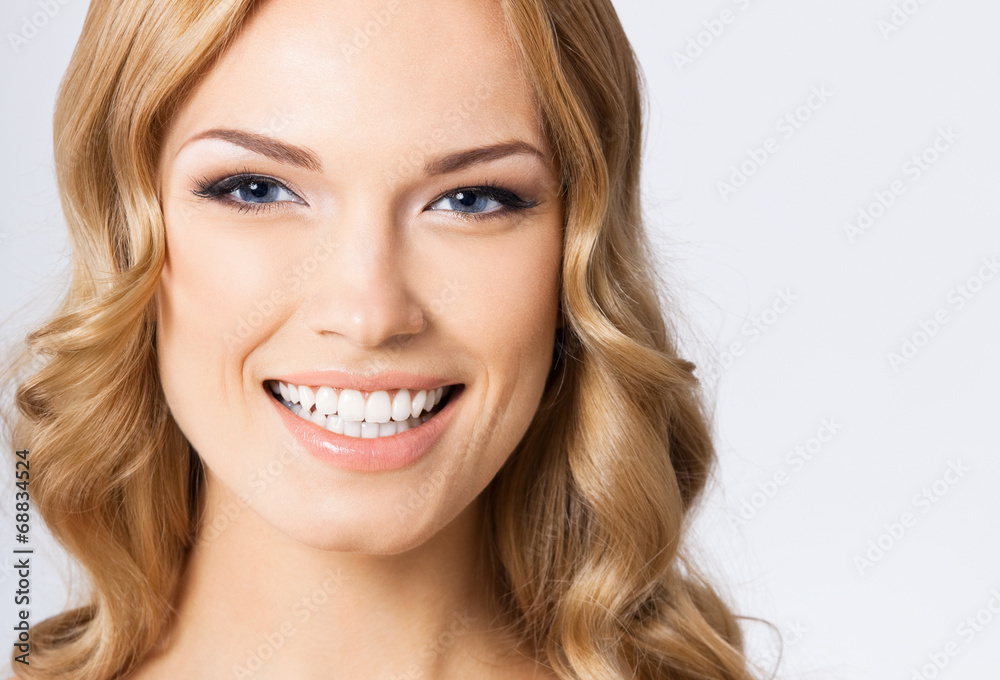 Young cheerful smiling woman, on gray Young cheerful smiling woman, on gray