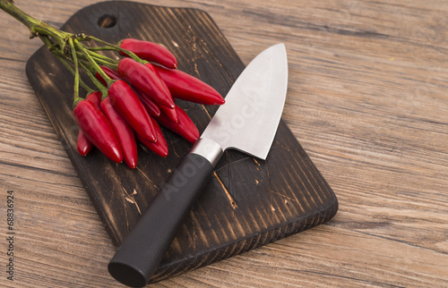 Red peppers with knife