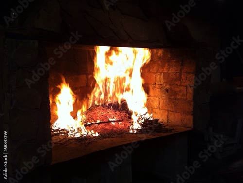 Fireplace with burning branches for cooking
