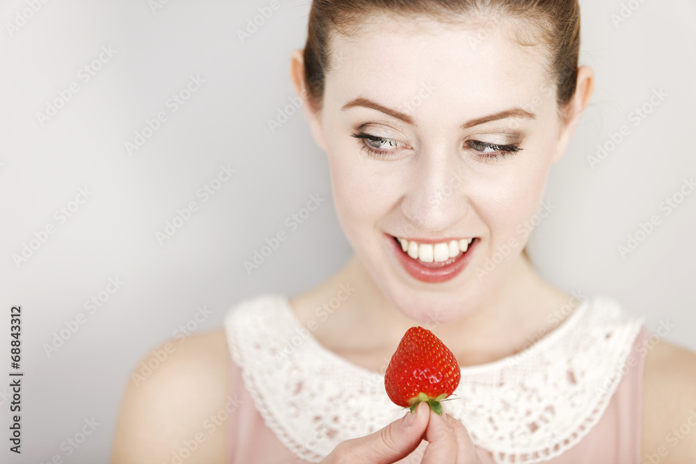 Woman eating a strawberry Woman eating a strawberry