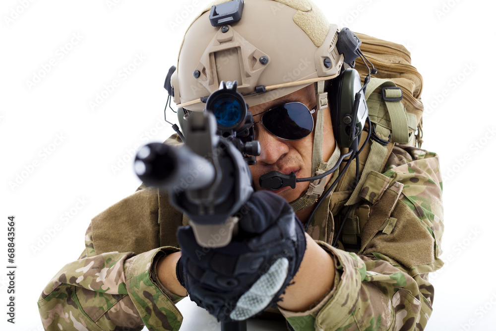 Fototapeta premium closeup of Soldier lying on floor with rifle over white