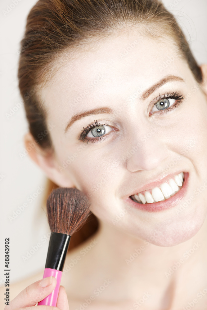 Woman applying make up