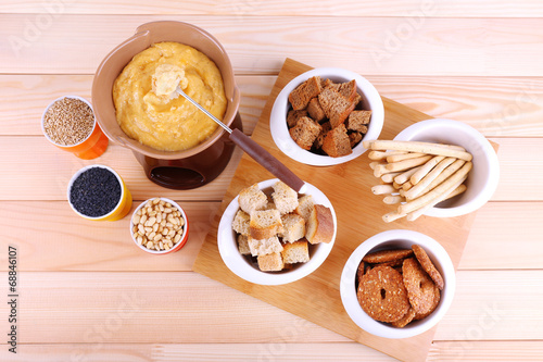 Fondue, little bowls of spice, rusk and biscuits