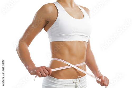 young athletic woman measuring waist