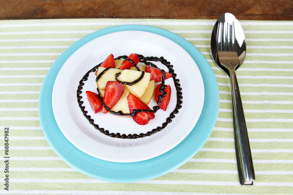 fresh tasty fruit salad on table, on wooden background fresh tasty fruit salad on table, on wooden background