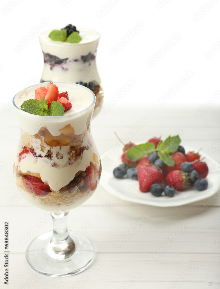 Natural yogurt with fresh berries on wooden table Natural yogurt with fresh berries on wooden table