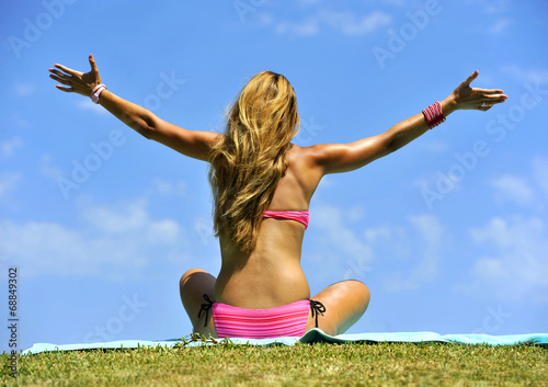 free sexy blonde woman in bikini opening arms to the sky
