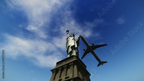 Airplane flying over the Statue of Liberty