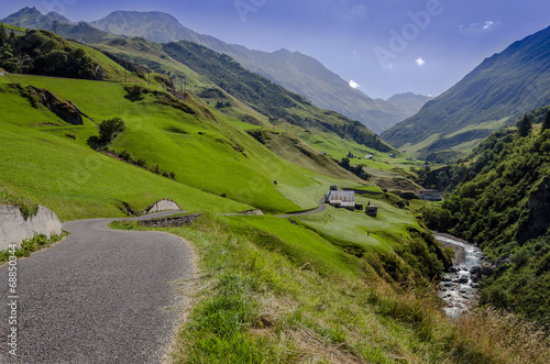 Beautiful Alpine valley with mountain river and road