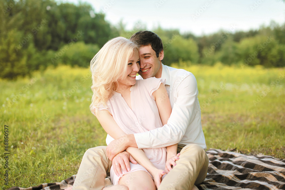 Pretty cheerful couple on picnic having fun enjoying summer Pretty cheerful couple on picnic having fun enjoying summer