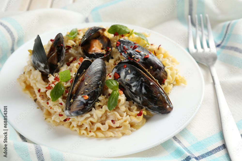 Traditional noodles with mussels on table, close up Traditional noodles with mussels on table, close up