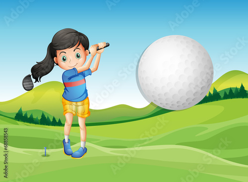 A young lady playing golf