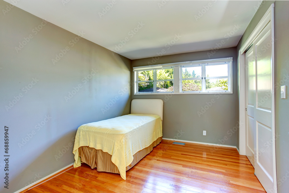 Obraz premium Empty house interior. Grey bedroom with single bed
