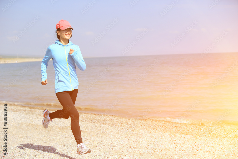 Runner athlete running on stone beach of qinghai lake