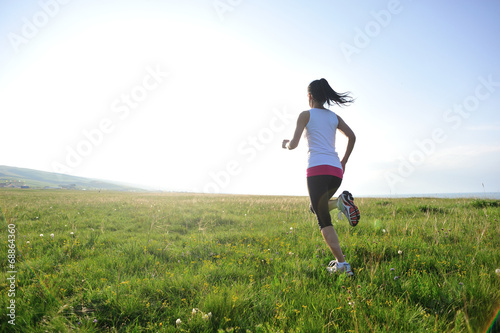 Runner athlete legs running on  grass seaside