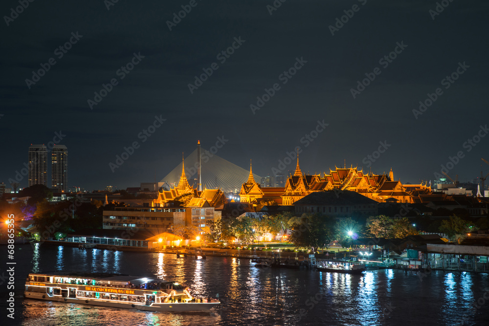 Grand palace and cruise ship in night ,Bangkok city ,Thailand