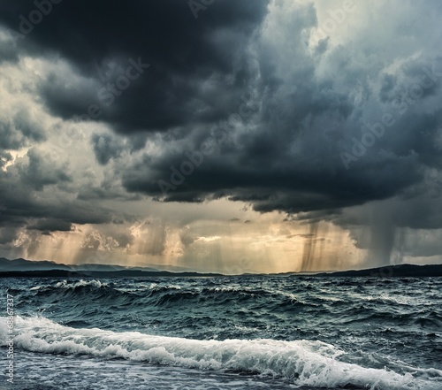 Heavy rain over stormy ocean © Nejron Photo