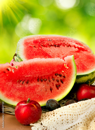 Juicy ripe organic watermelon closeup over nature background