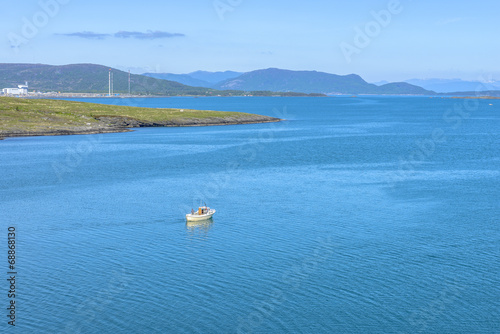 Fisherman sailing in the sea at spring in Rogaland, Norway photo