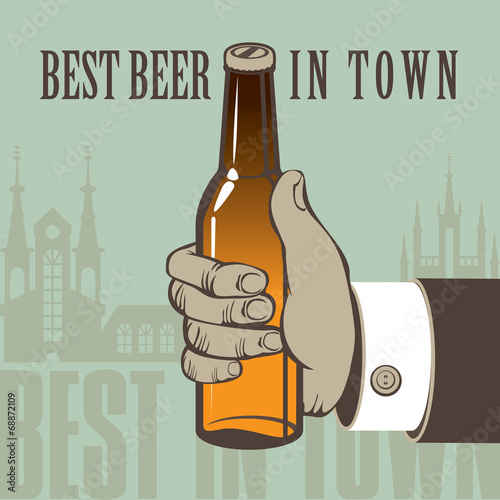human hand with a bottle of beer in old town
