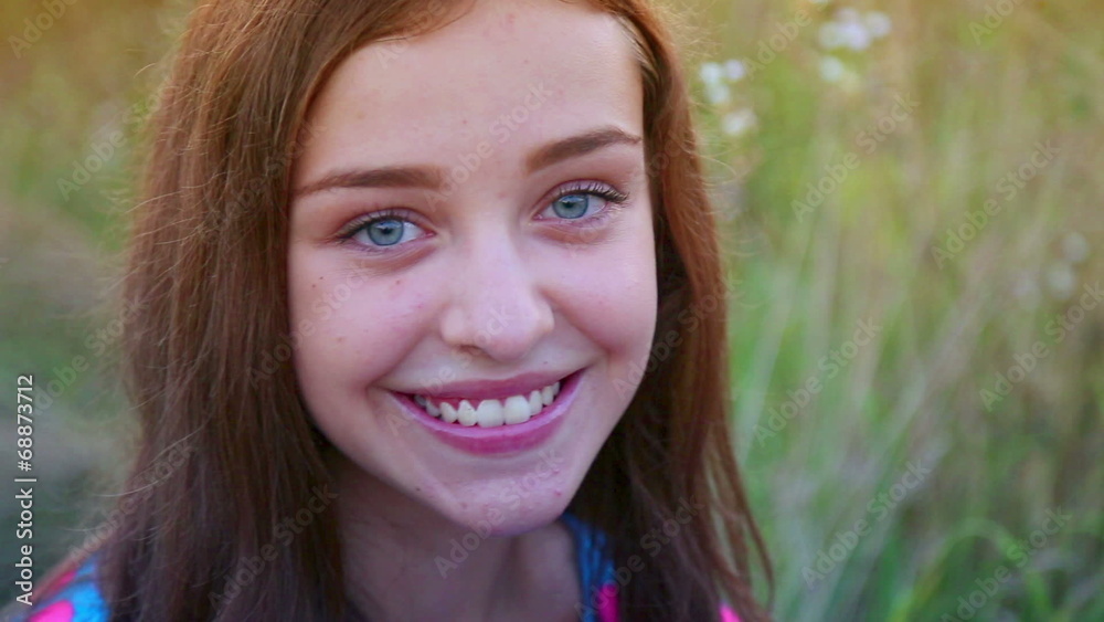 Portrait of a young, beautiful girl, smiling at the camera. Portrait of a young, beautiful girl, smiling at the camera.