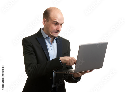 Angry businessman with laptop computer