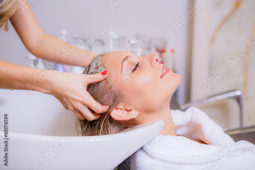 Hairdresser washes head girl