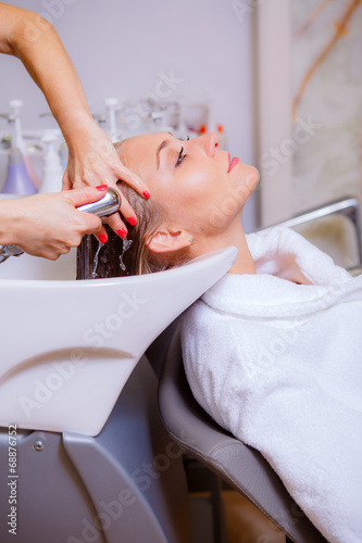 Hairdresser washes head girl