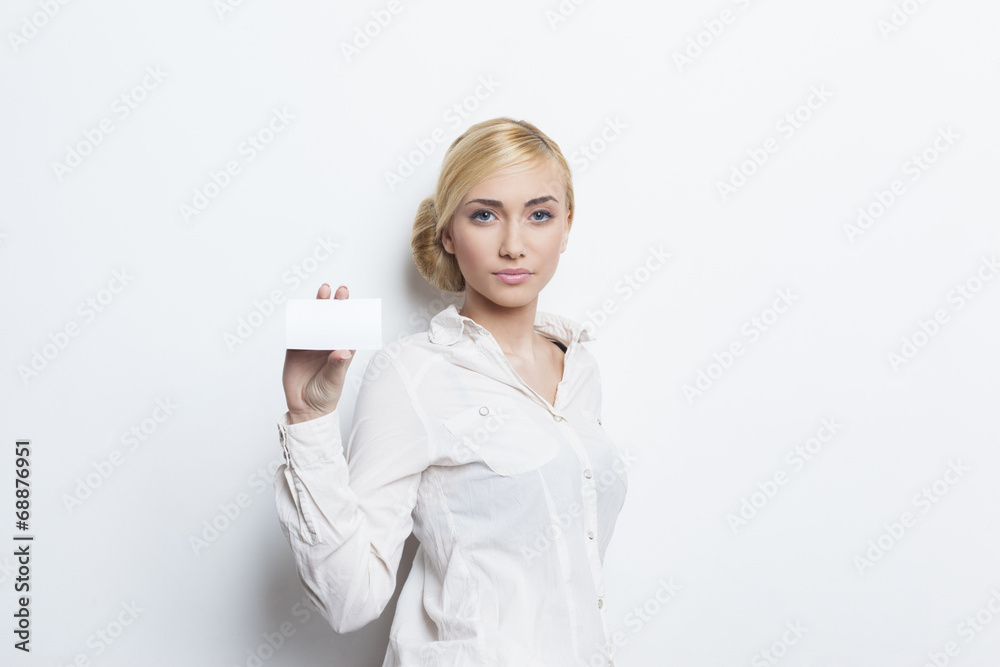 Beautiful blonde girl holding blank business card Beautiful blonde girl holding blank business card