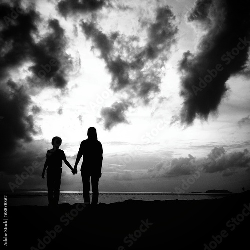 mother and son in silhouette
