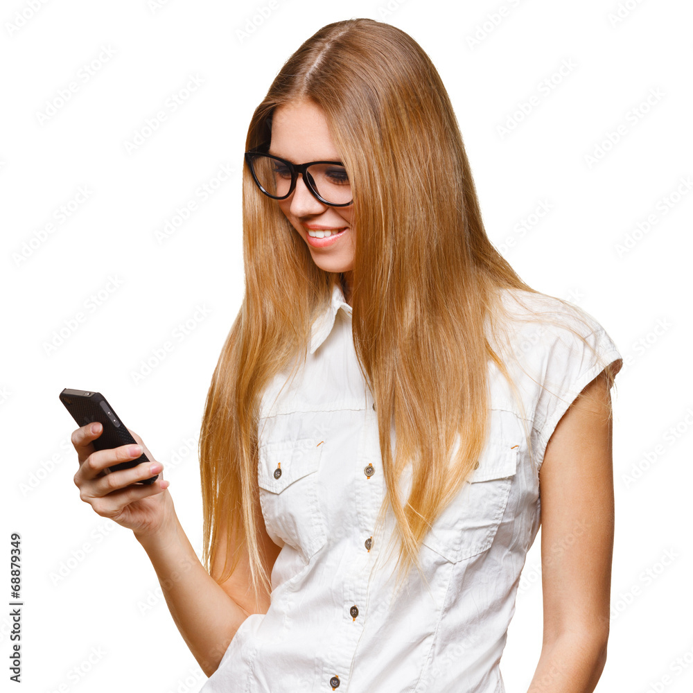 Happy smiling woman holding a mobile phone while text messaging Happy smiling woman holding a mobile phone while text messaging