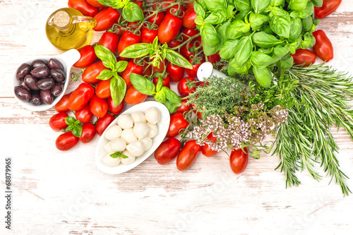 tomatoes, basil leaves, mozzarella and olive oil. food backgroun
