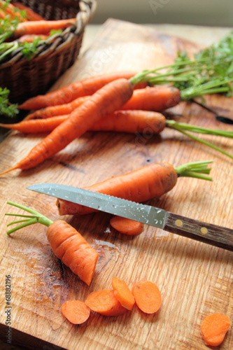 Cutted carrots on a wooden board in a kitchen