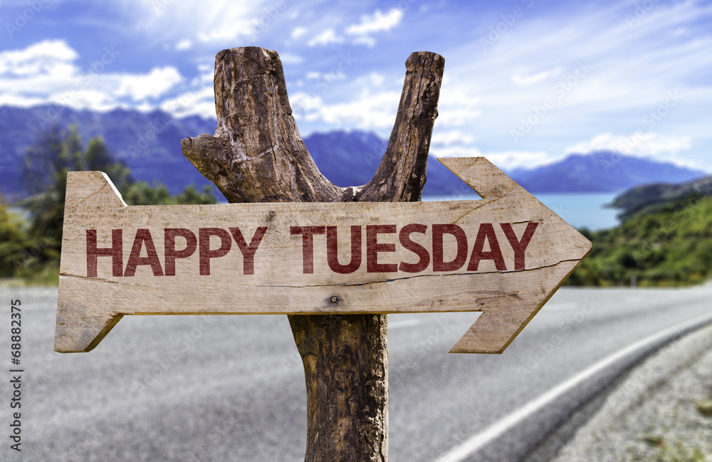 Happy Tuesday wooden sign with a street background