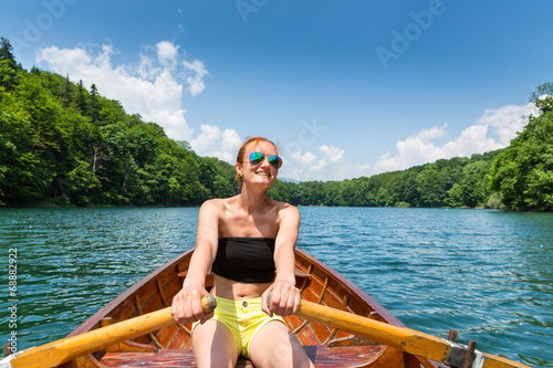Happy girl in wooden boat