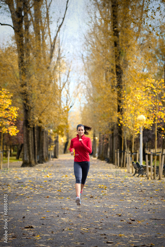 Woman running in autumn park