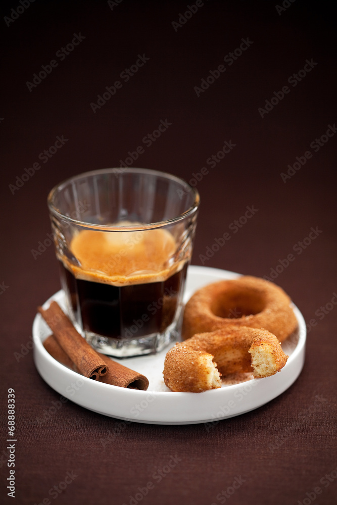 Donuts with cinnamon and coffee, selective focus