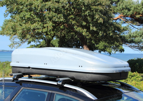 Roof box on car with railing