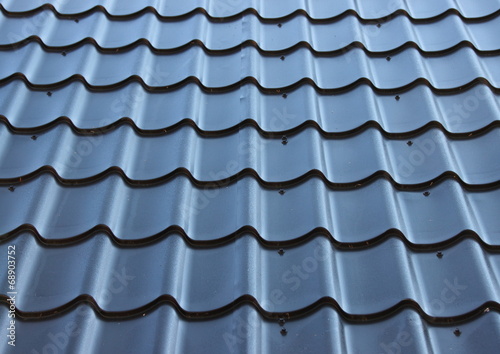 Curved black metal roof with wave design