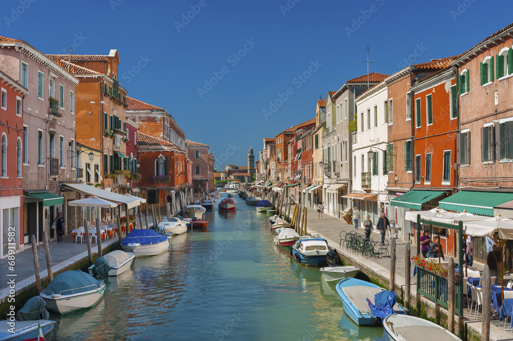 Murano island canal, colorful houses and boats, Italy.