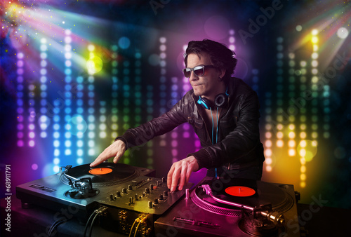 Dj playing songs in a disco with light show