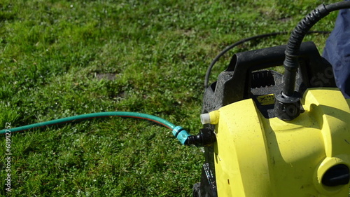 man hand detach water hose to high pressure wash equipment