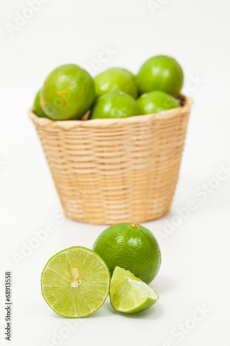 Green lemon in wood basket