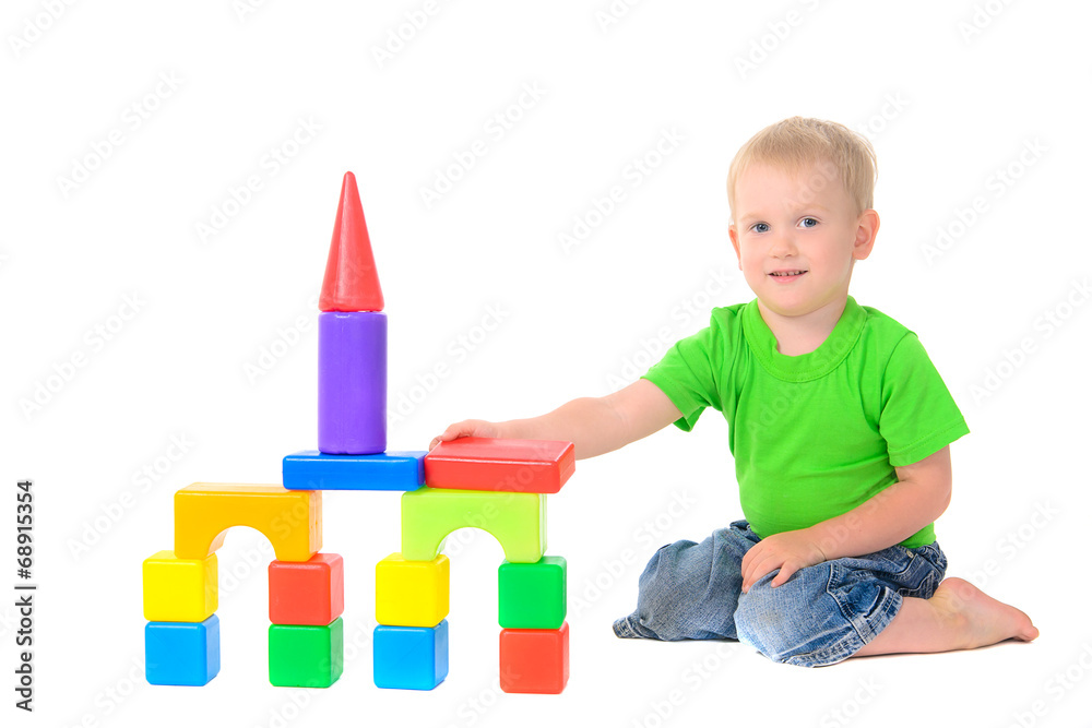 boy builds a building of colored cubes boy builds a building of colored cubes