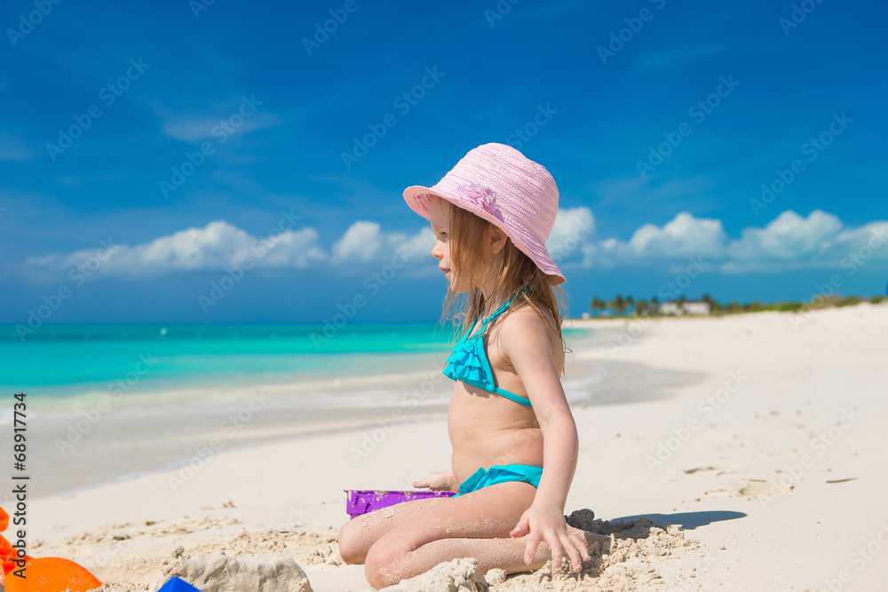 Little girl playing with beach toys during carribean vacation