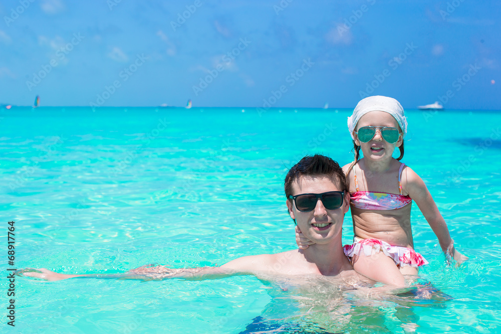 Happy father play with little daughter in perfect sea