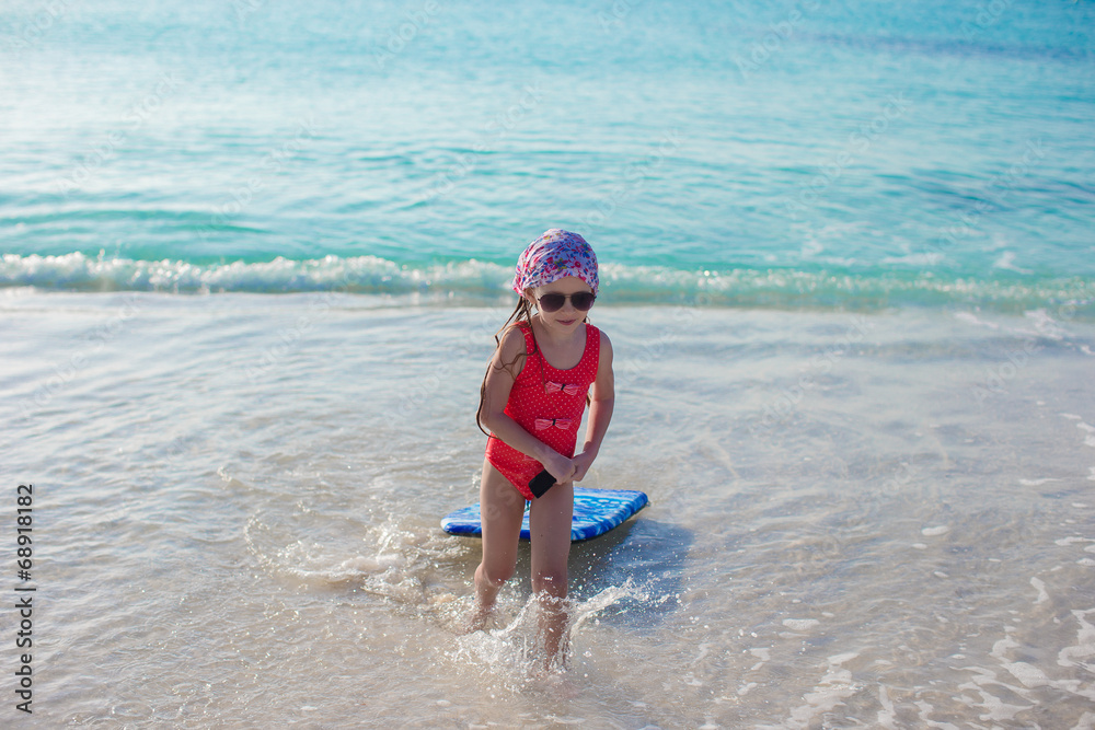 Adorable little girl in the sea on tropical beach vacation Adorable little girl in the sea on tropical beach vacation