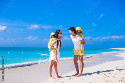 Happy family of four on caribbean holiday vacation