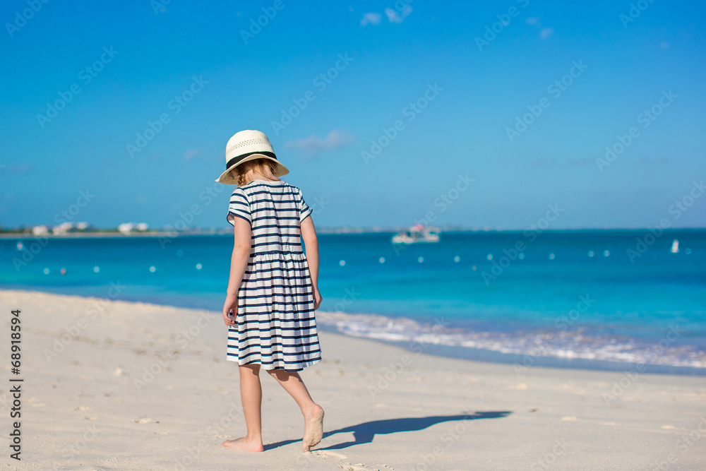 Little cute girl in hat at beach during caribbean vacation