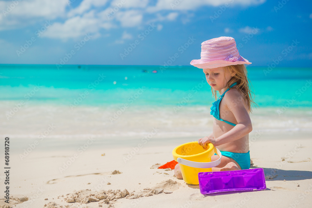 Adorable little girl playing with toys on beach vacation Adorable little girl playing with toys on beach vacation